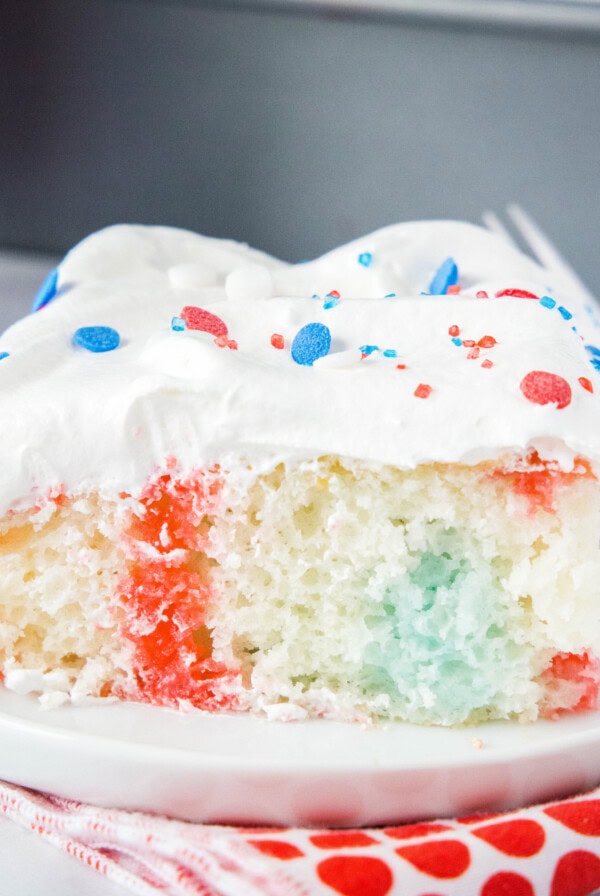 close up 4th of july poke cake on a plate