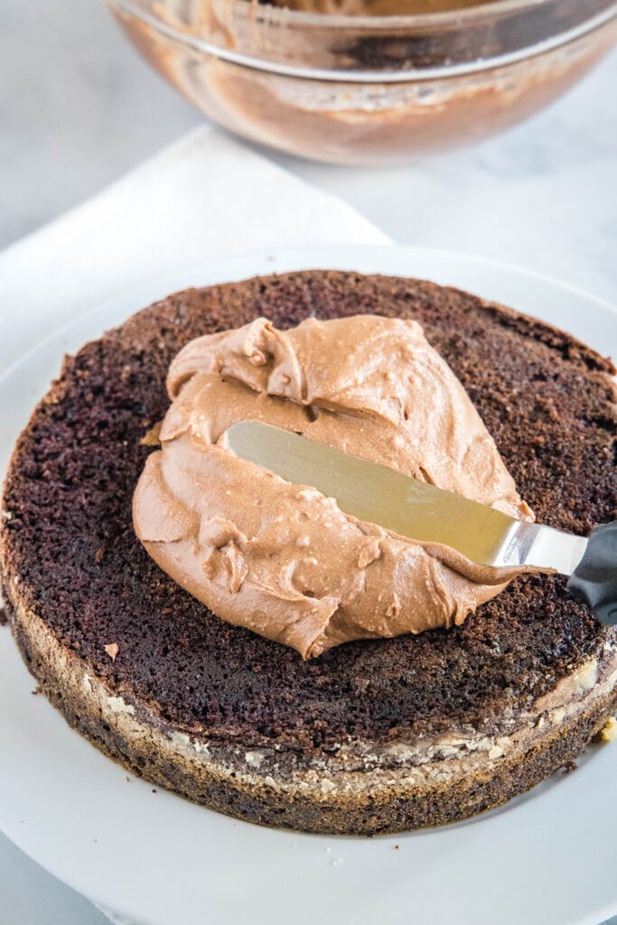 putting frosting on a cake