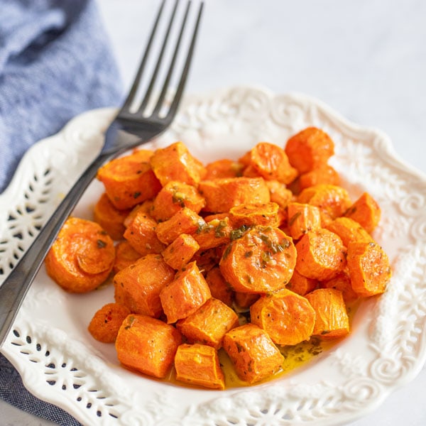 cooked carrots on a plate with fork