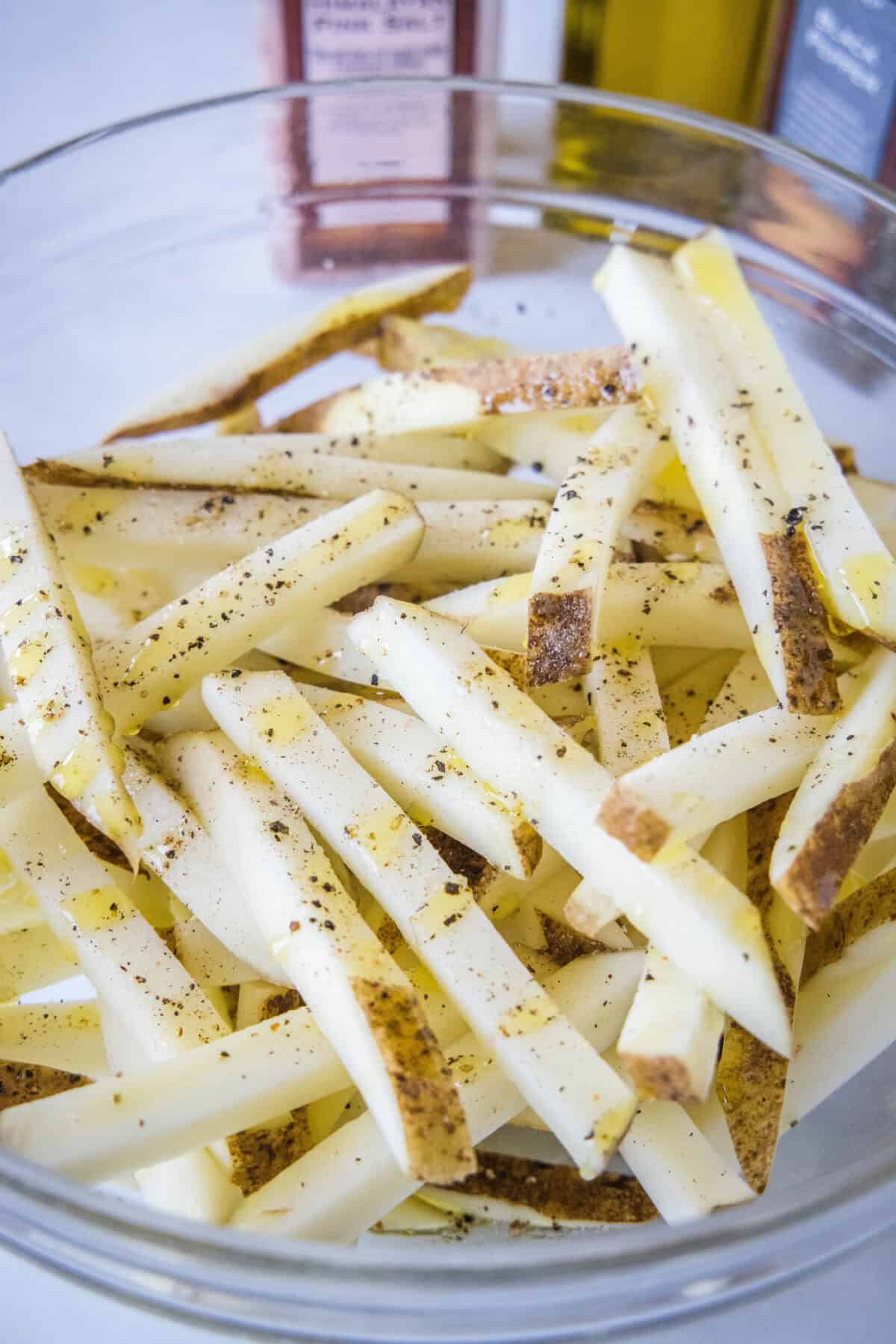 Cut and seasoned French fries in a bowl.