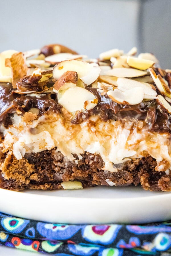 close up almond joy brownie on a white plate