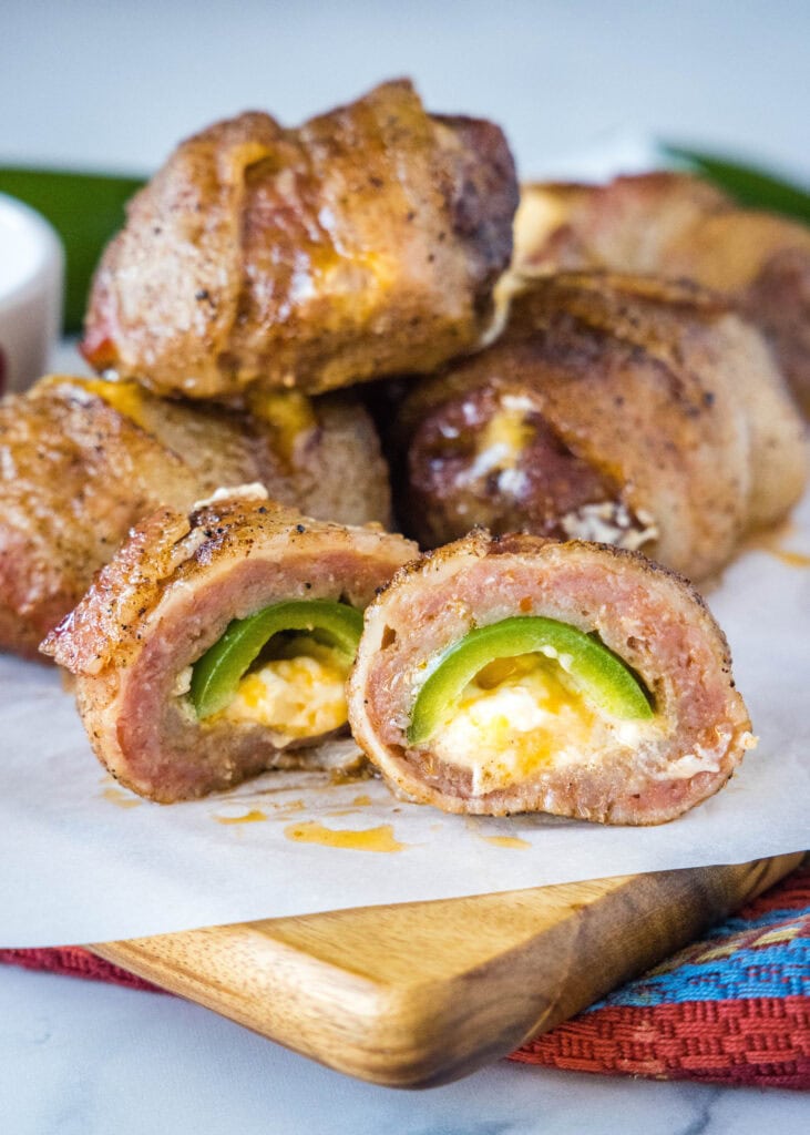 smoked armadillo eggs cut in half on a cutting board