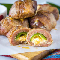 cropped in close up of armadillo eggs cut in half on a cutting board