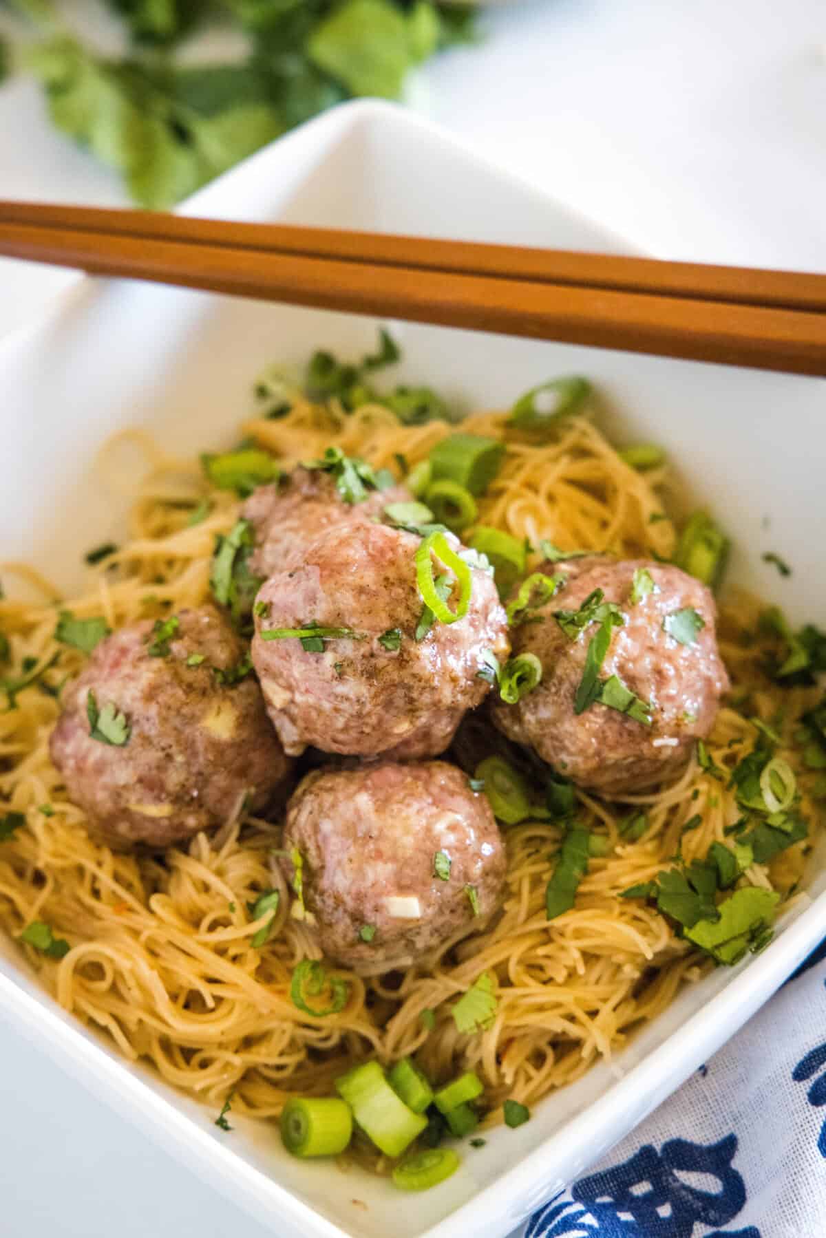 looking down on a asian meatballs over rice noodles