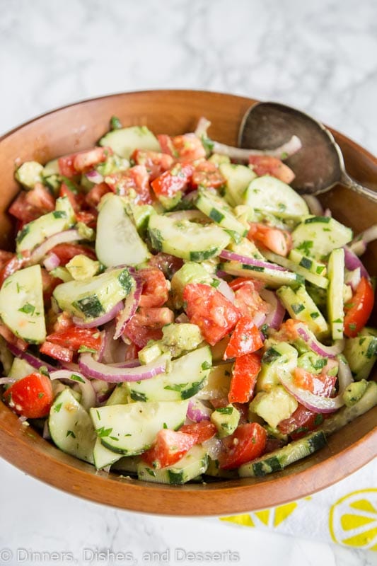 A bowl of food, with Salad and Tomato