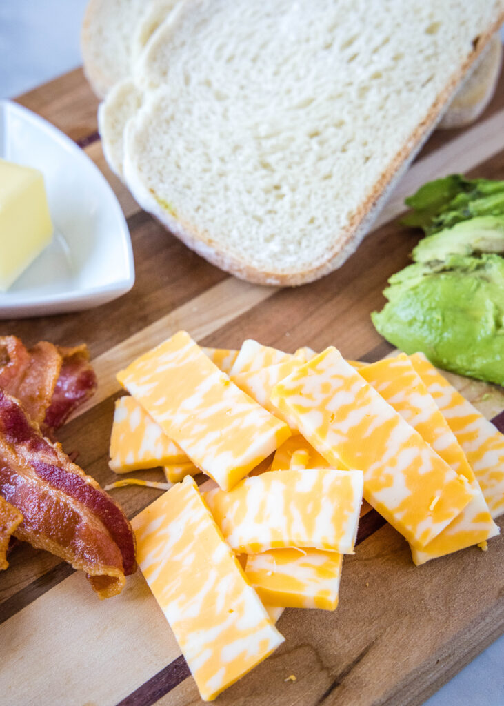 ingredients on a cutting board for avocado grilled cheese sandwich