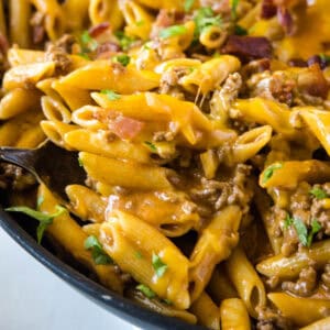 cropped close up bacon cheeseburger pasta in skillet