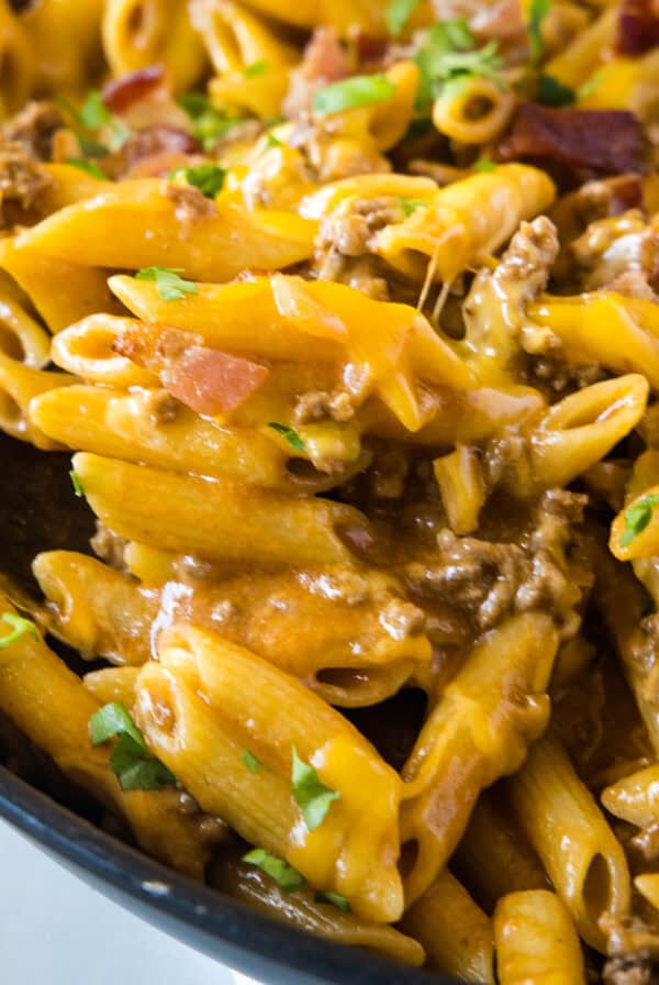 cropped close up bacon cheeseburger pasta in skillet