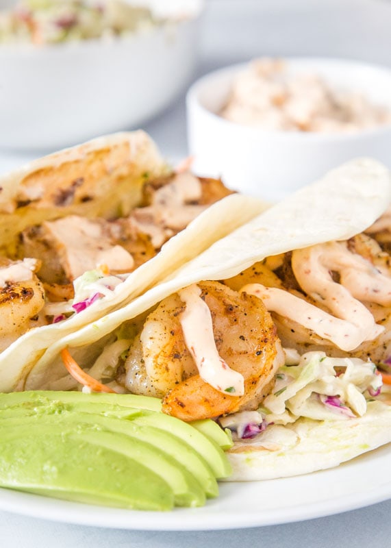 tacos with sliced avocado on plate