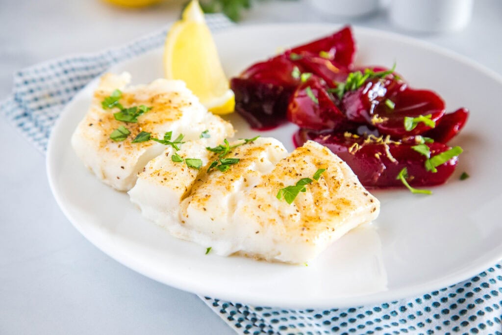 Easy Baked Cod - an easy oven baked cod recipe that is lightly seasoned and topped with melted butter!  Served with Harvard Beets for a delicious meal.