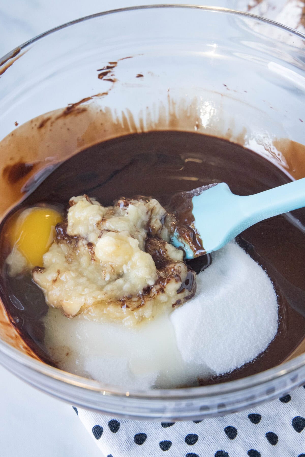 mixing banana brownie ingredients together in mixing bowl