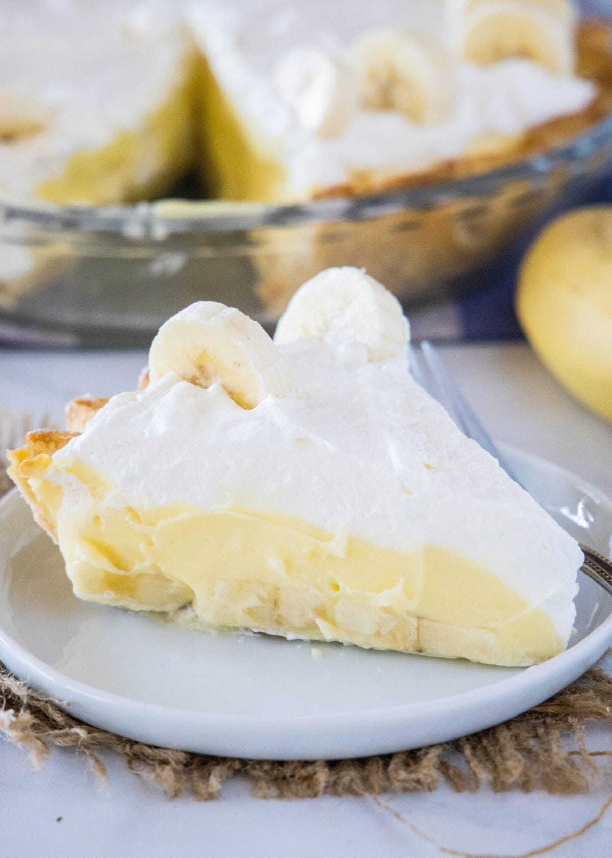 A slice of banana cream pie on a plate