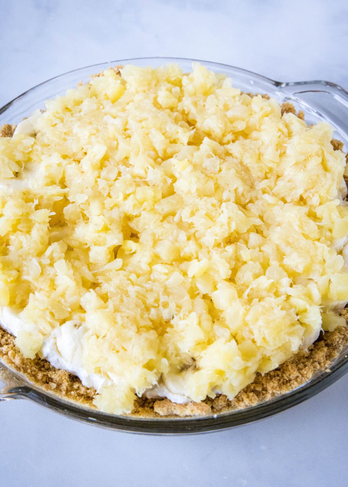 Crushed pineapple layered over top a banana split pie.