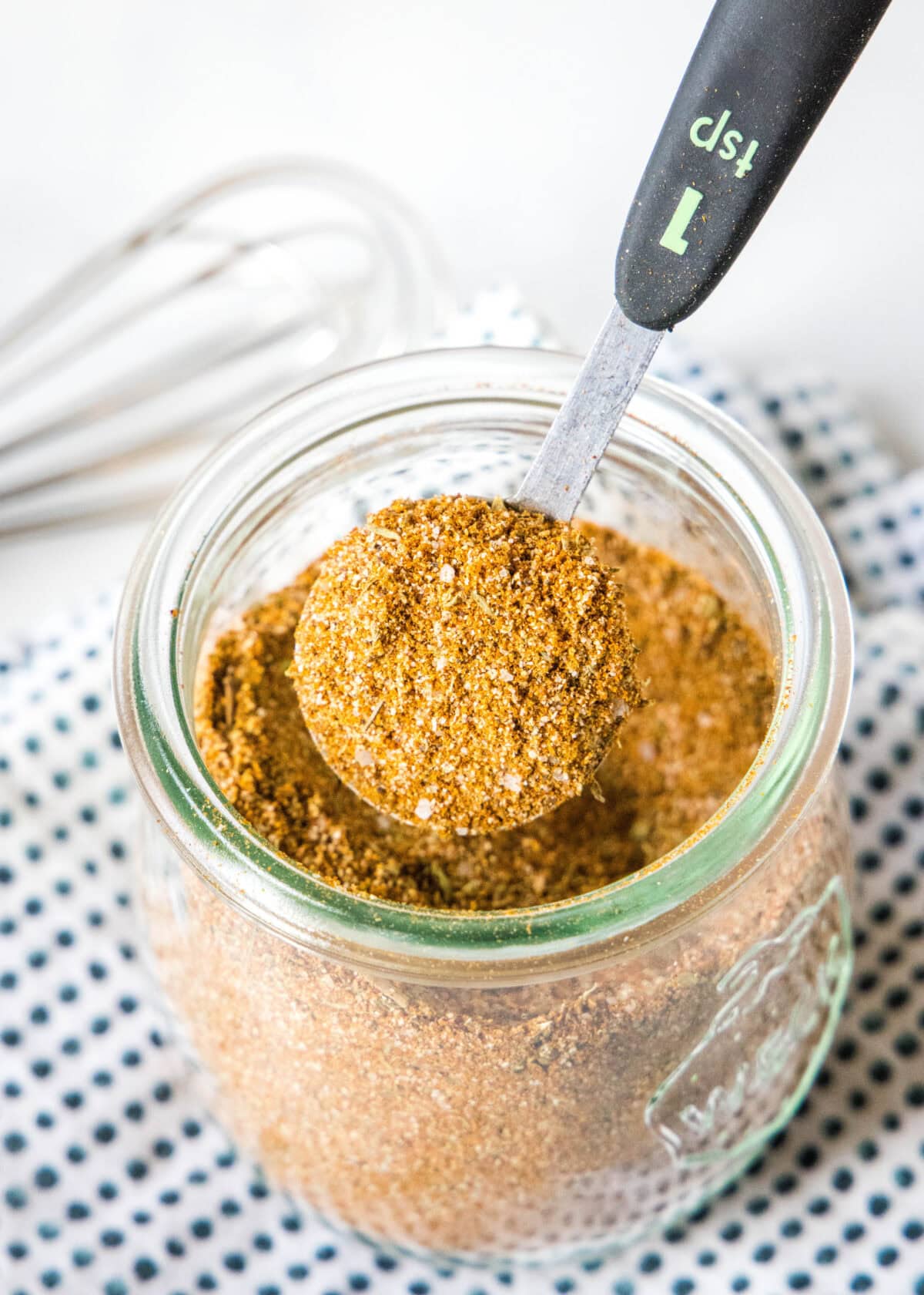 scooping seasoning from spice jar