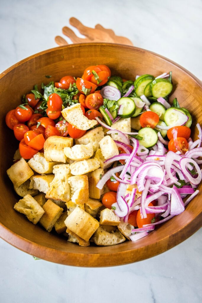 ingredients for bread salad in a large bowl