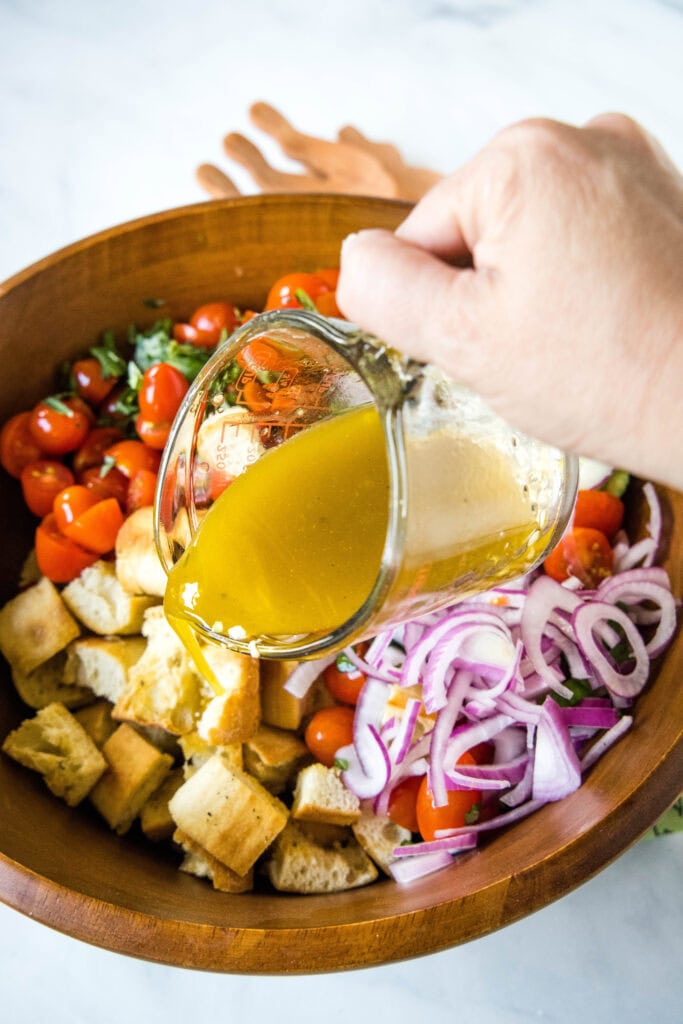 pouring dressing over salad