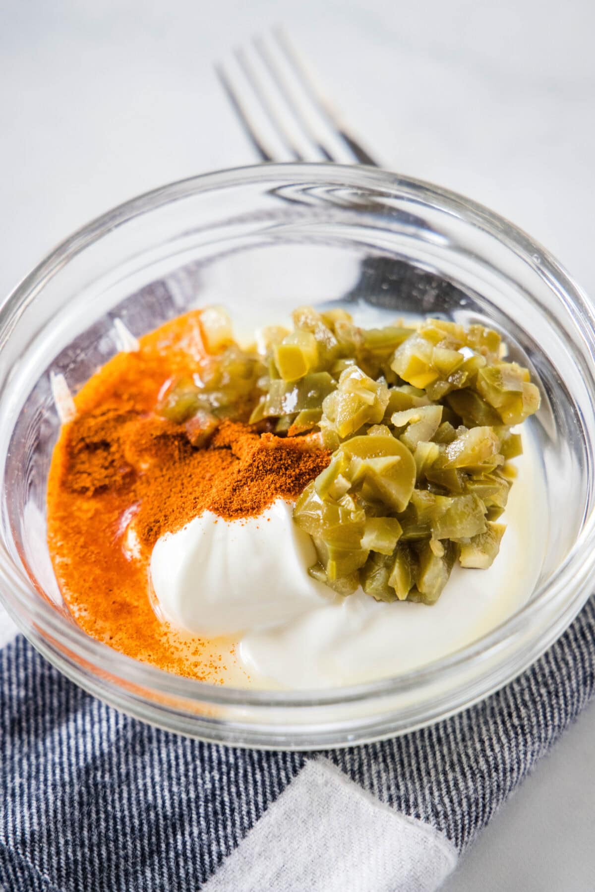 Creamy jalapeño sauce ingredients combined in a glass bowl.
