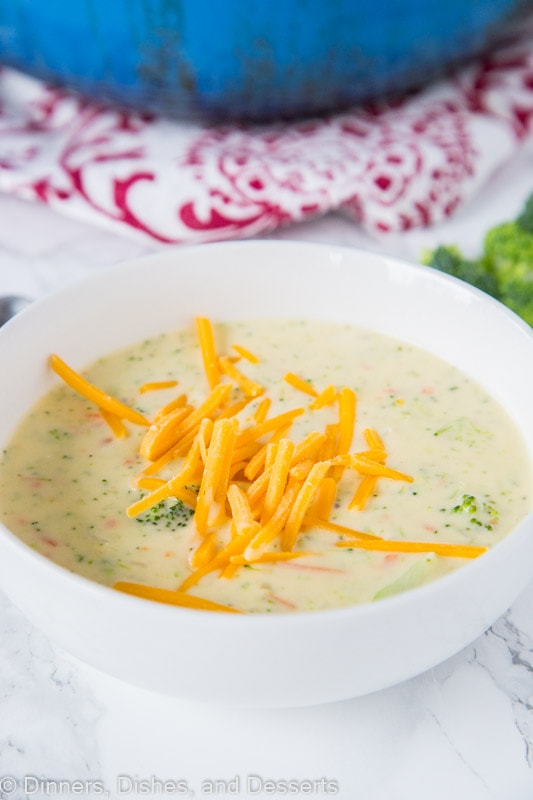 A bowl of broccoli cheese sou with cheese