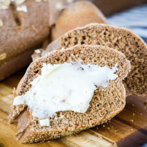 slice of bread with butter on a cutting board