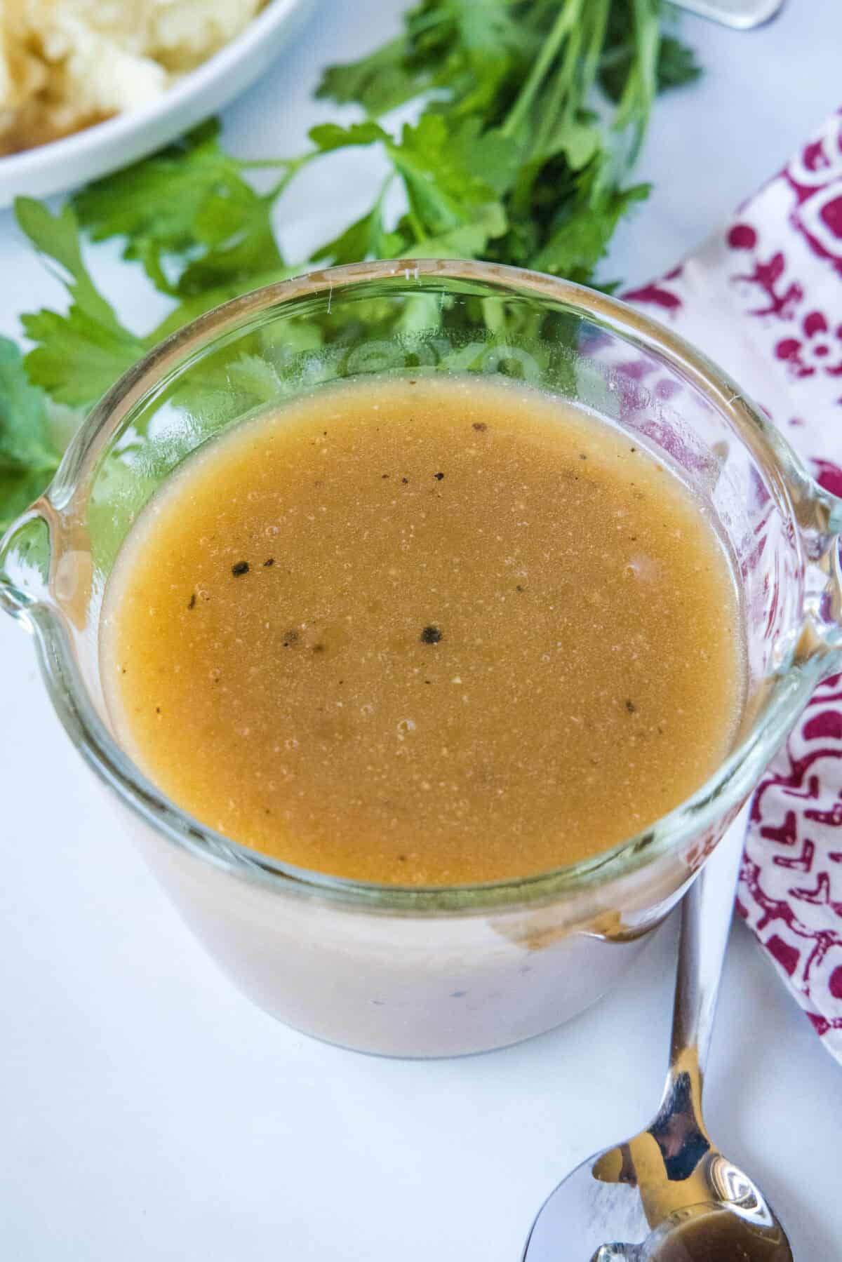 looking down on brown gravy in a measuring cup