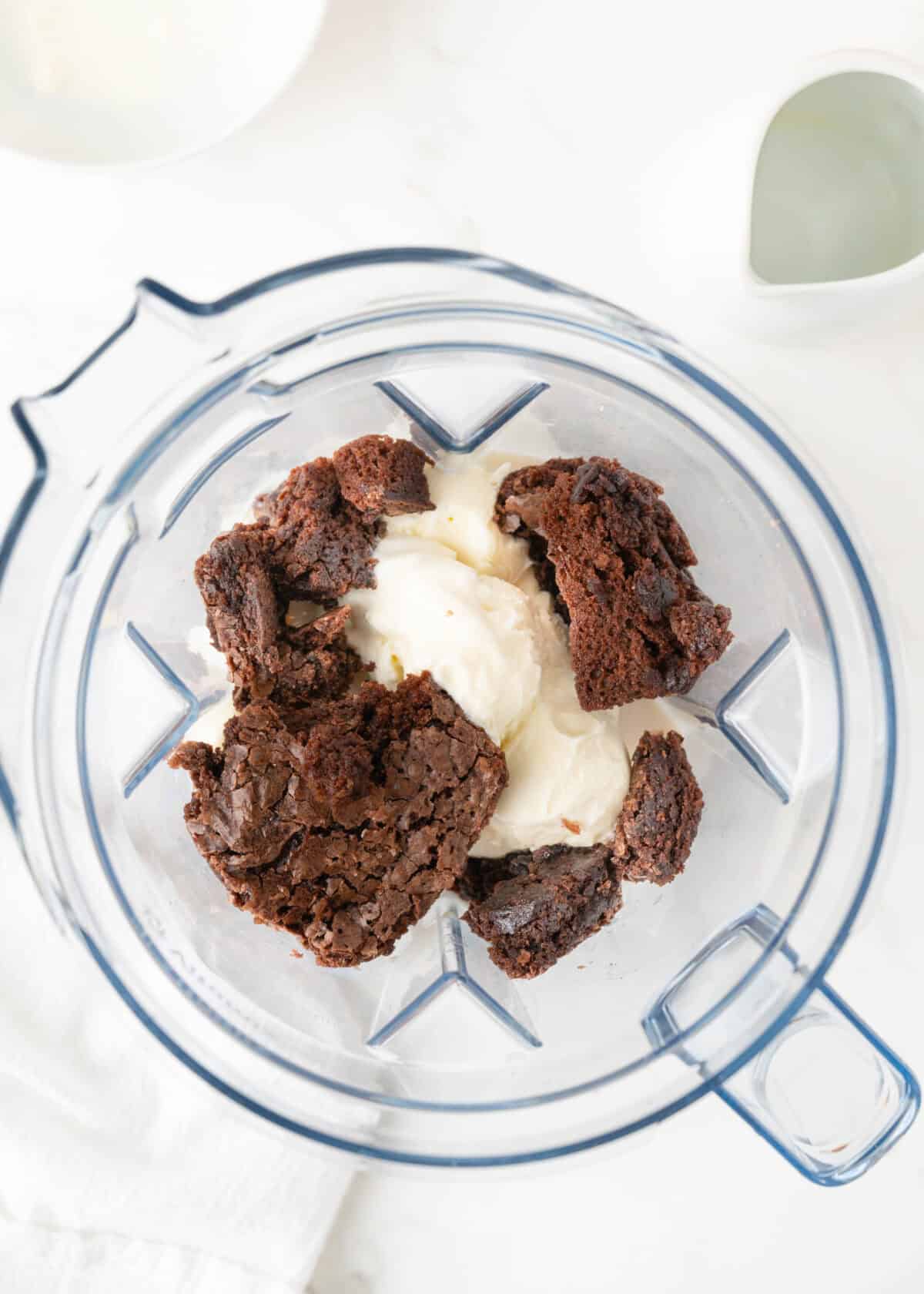 adding ingredients to blender for brownie milkshakes
