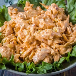 close up buffalo chicken salad on bed of greens