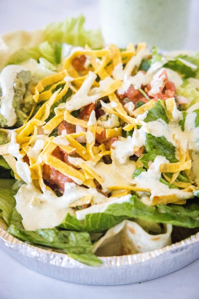a salad topped with cafe rio dressing