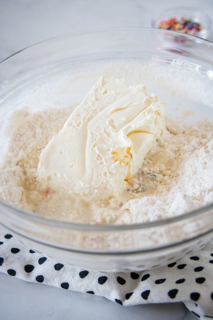 Cake batter dip ingredients combined in a glass bowl.