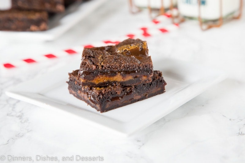 chocolate caramel brownies stacked on a plate