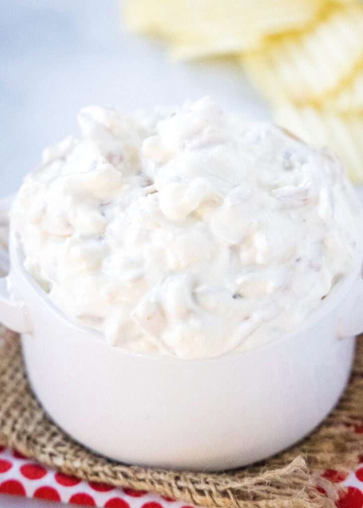 onion dip in a white bowl with potato chips