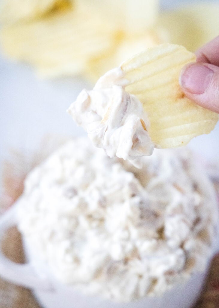 scooping onion dip onto a chip