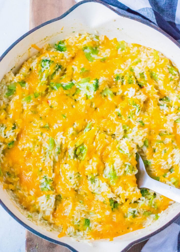 dish of cheesy broccoli rice with spoon
