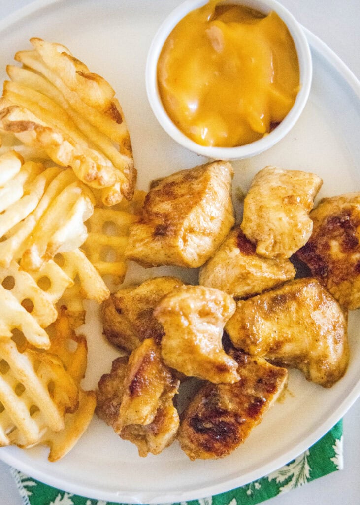 looking down on a plate of chick fil a grilled nuggets and waffle fries