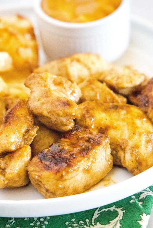 close up grilled chicken pieces on a white plate