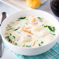 A bowl of soup on a table, with Olive Garden