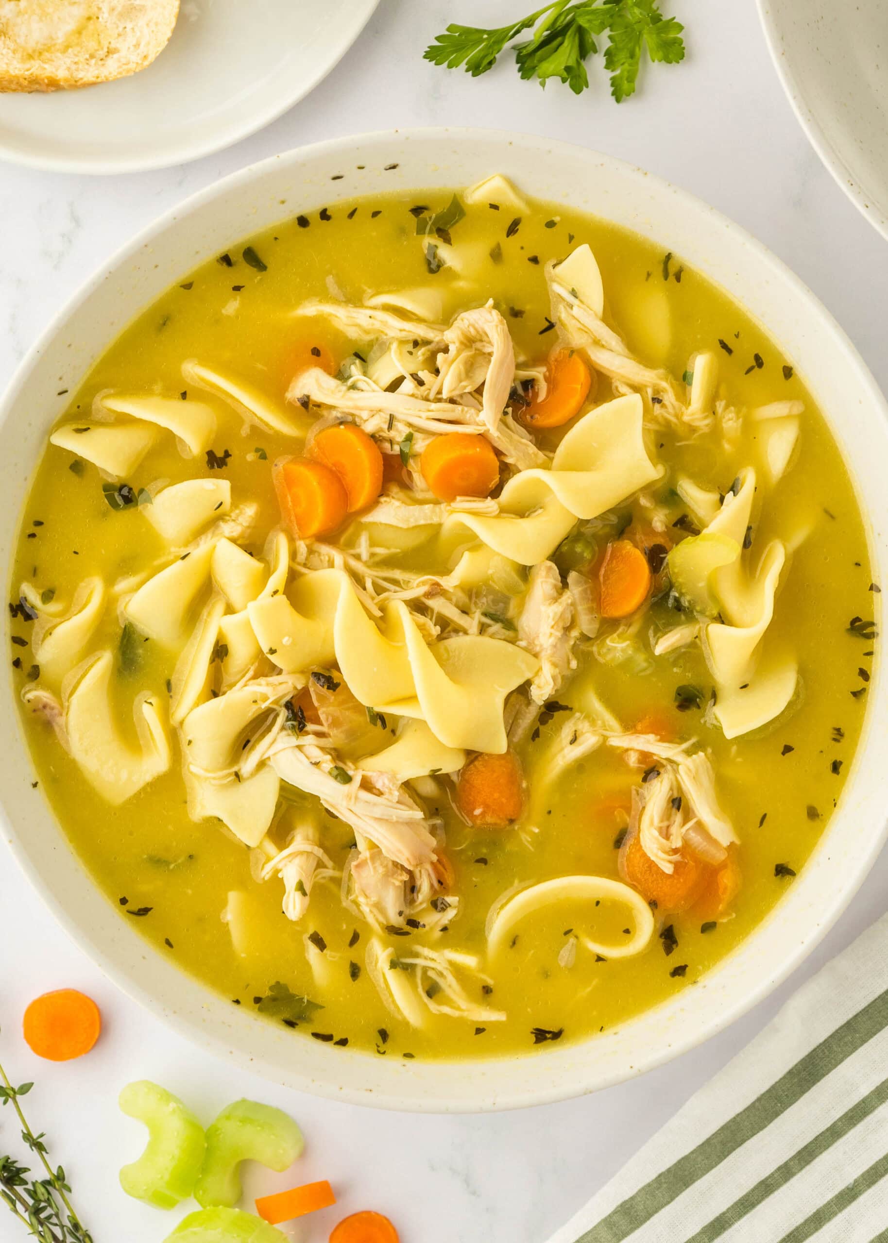 looking down on a bowl of chicken noodle soup