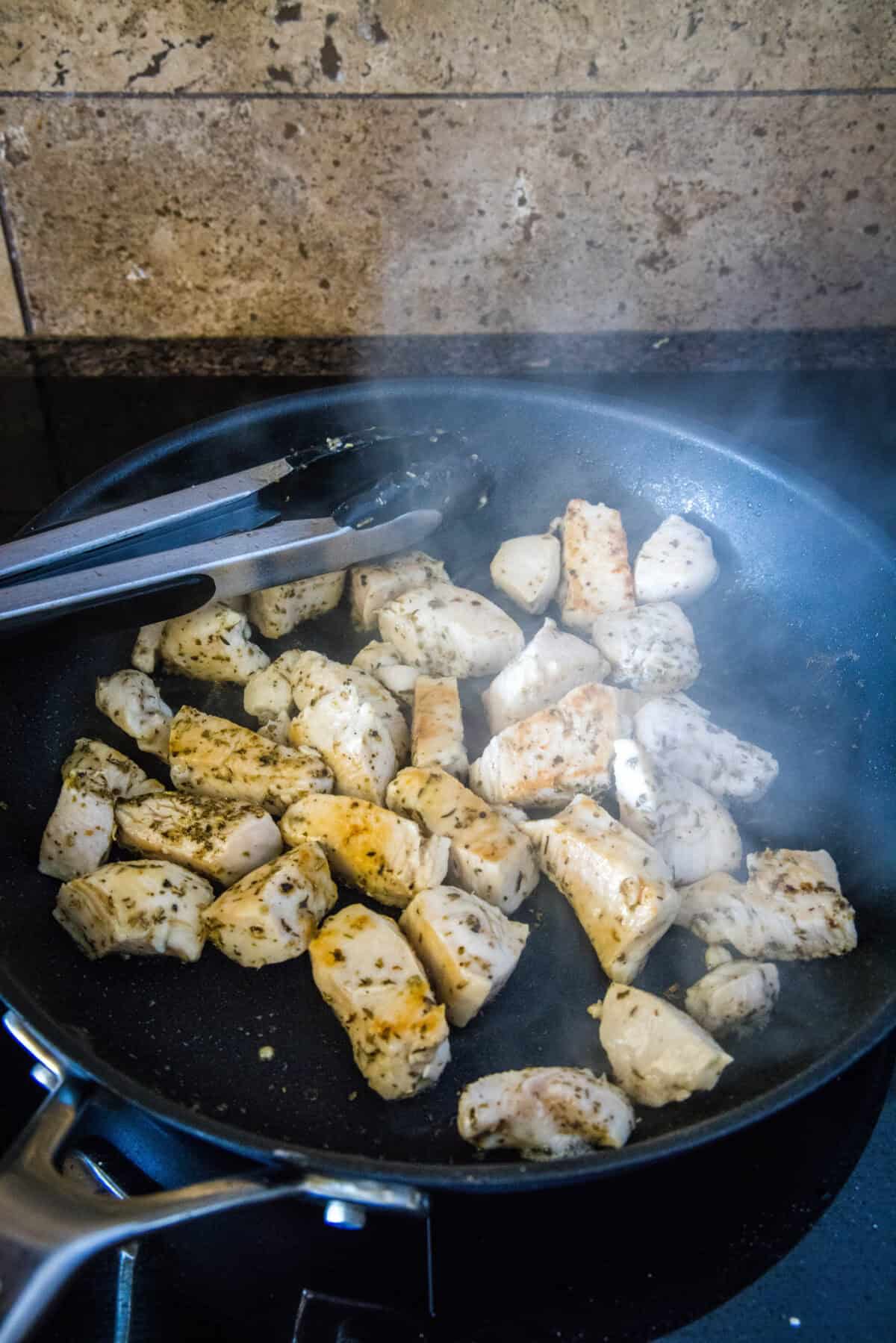 chicken browning in a skillet
