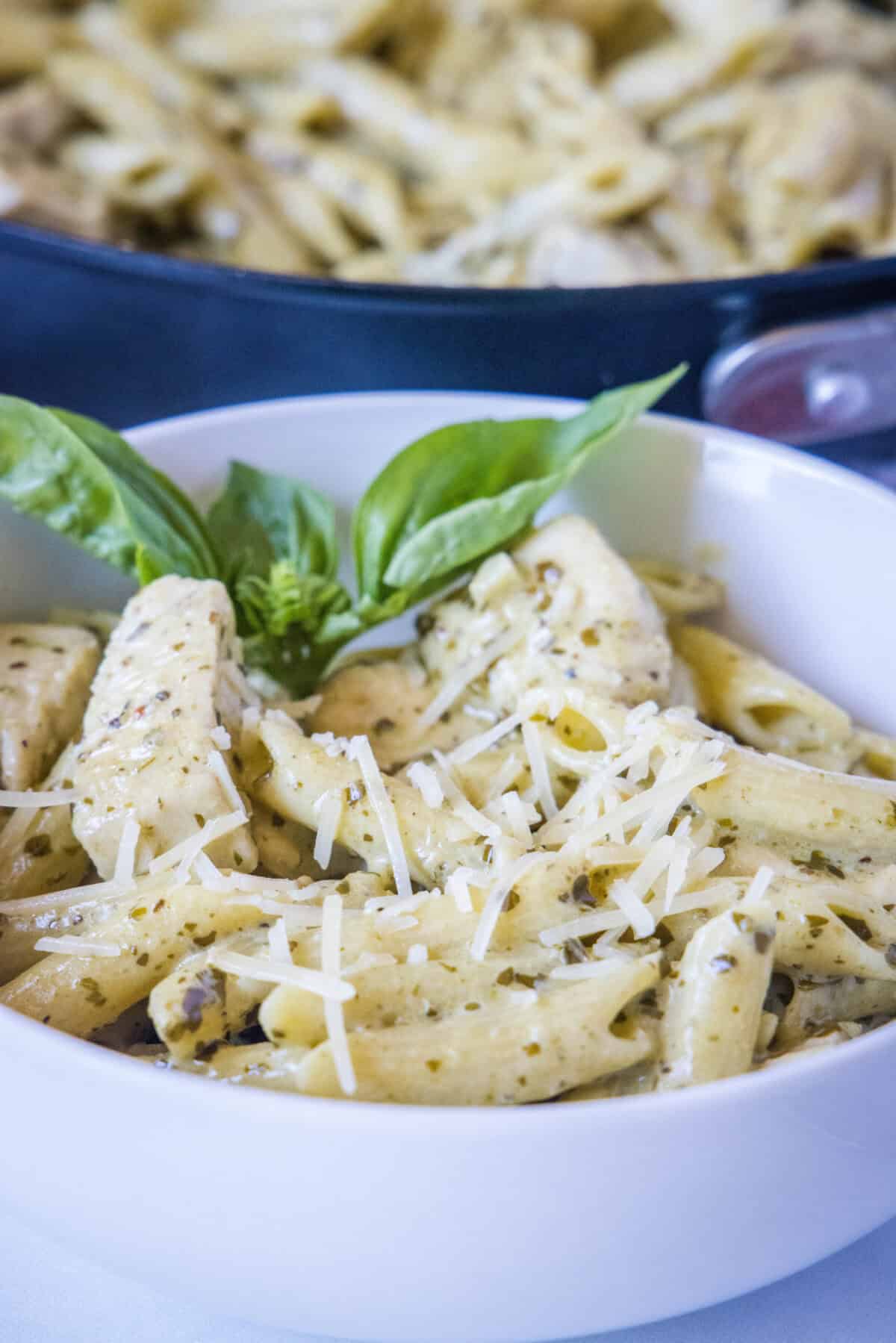 white bowl with chicken pesto pasta