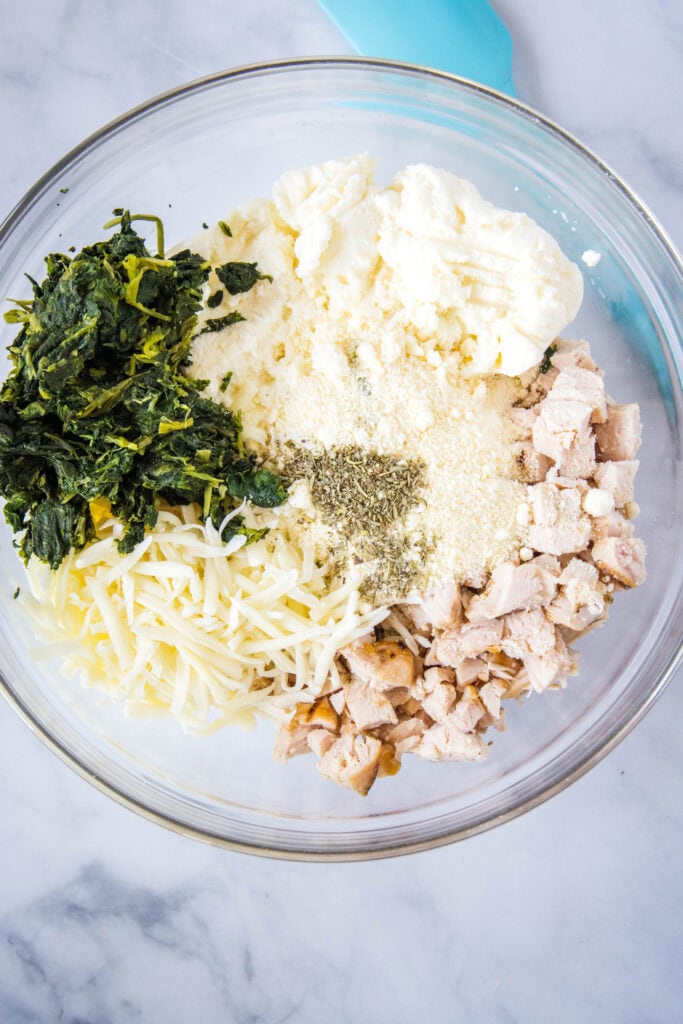 alfredo stuffed shells ingredients in a mixing bowl