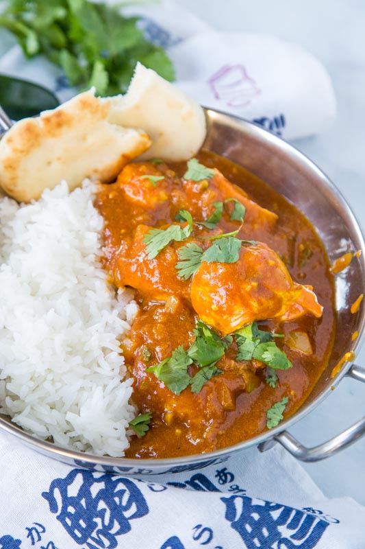 vindaloo curry in bowl with rice and naan