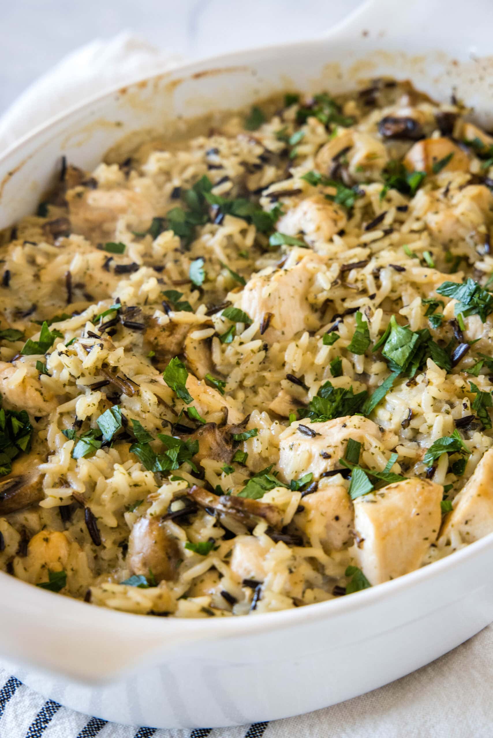 Chicken wild rice casserole in an oval baking dish.