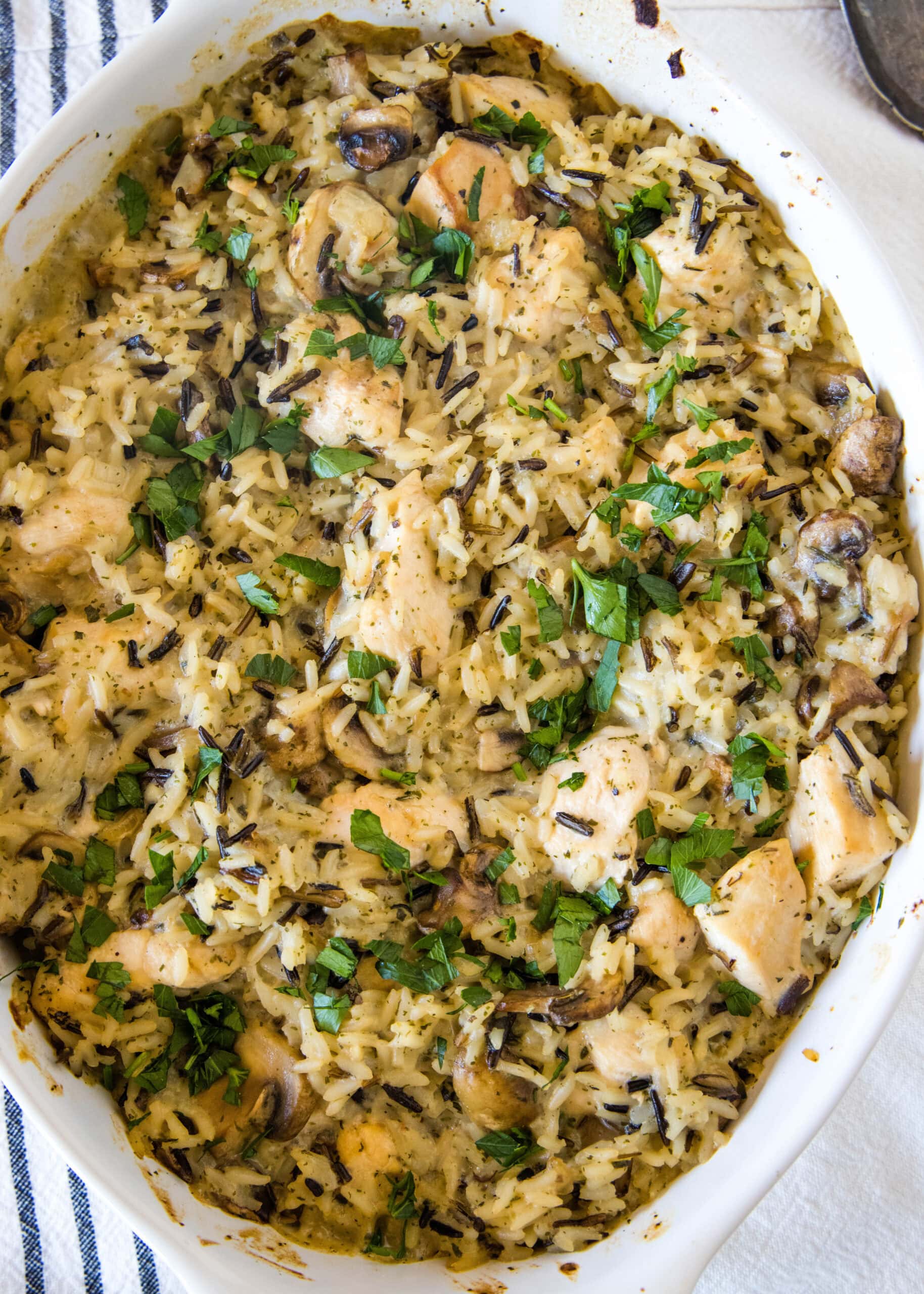 Overhead view of chicken wild rice casserole in an oval baking dish.
