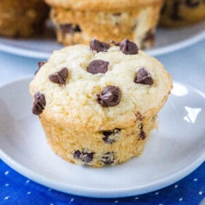 close up chocolate chip muffin on a white plate