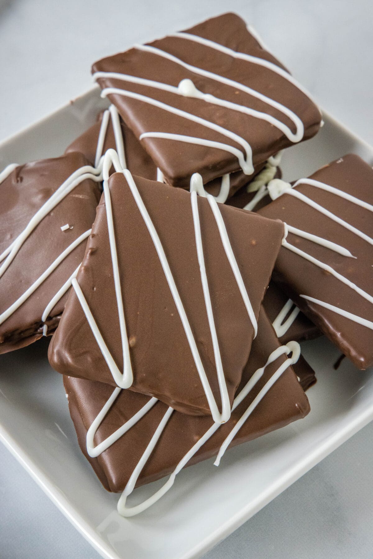 chocolate covered graham crackers on a white plate