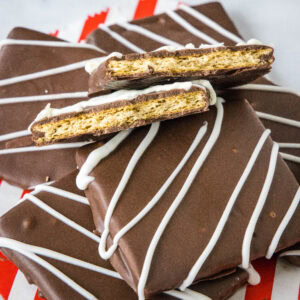close up chocolate covered graham crackers with one cut in half