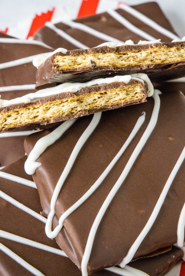 close up chocolate covered graham crackers with one cut in half