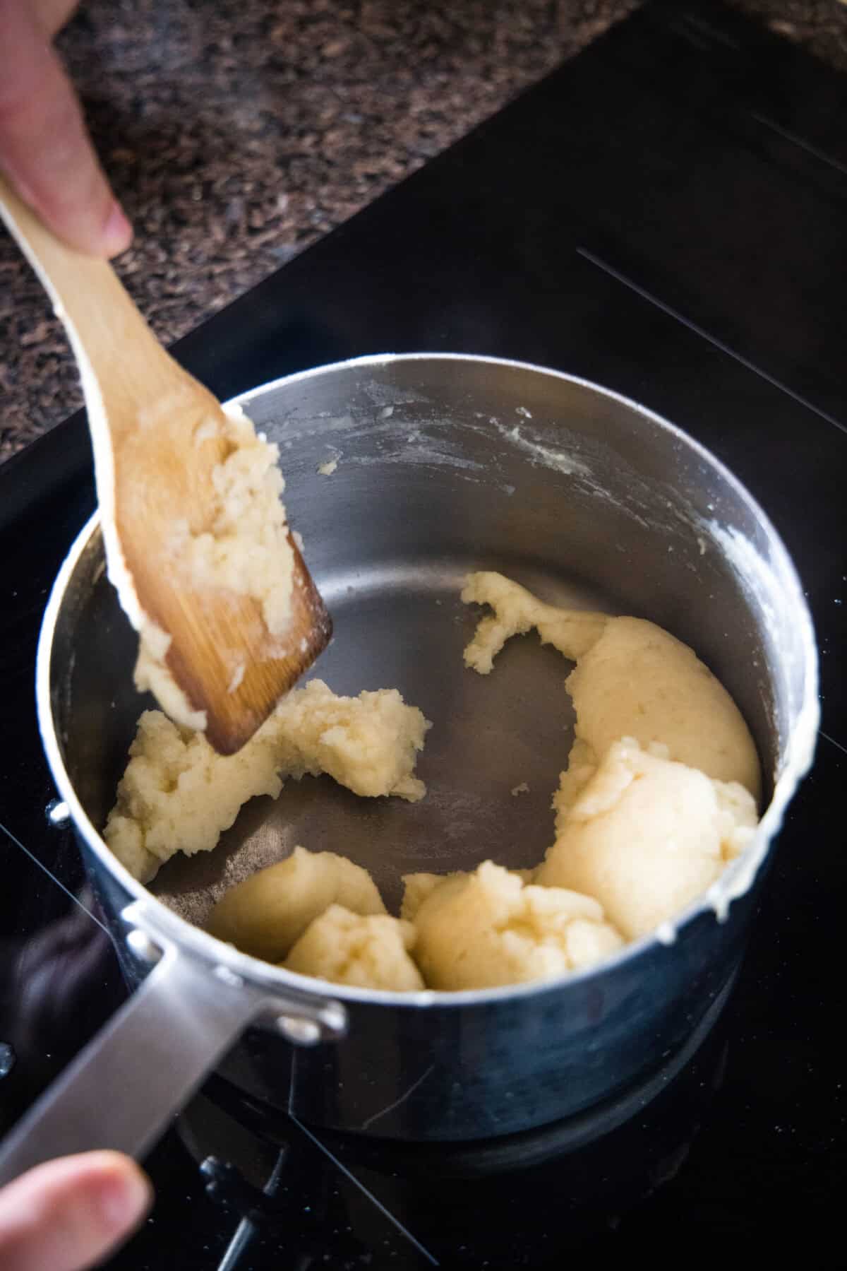 Pastry dough ingredients coming together in a saucepan.