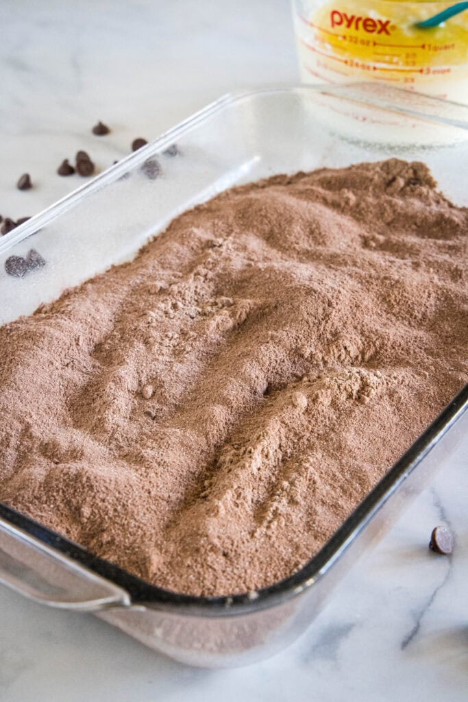 Chocolate cake mix in a 9x13-inch glass baking dish.