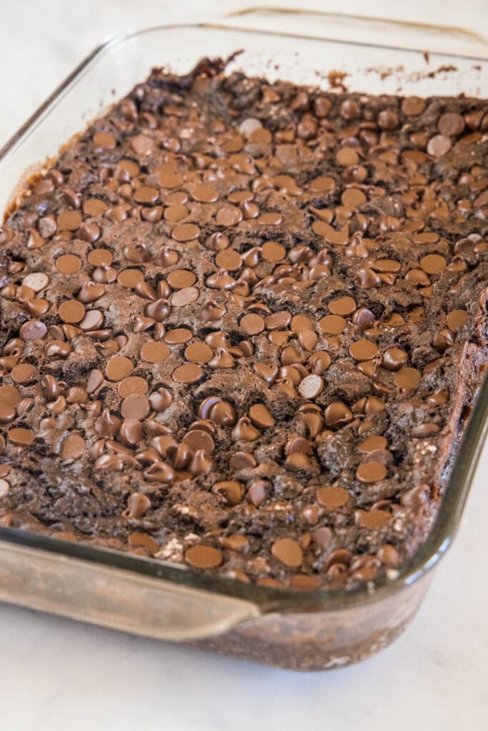 Baked chocolate dump cake in a glass baking dish.