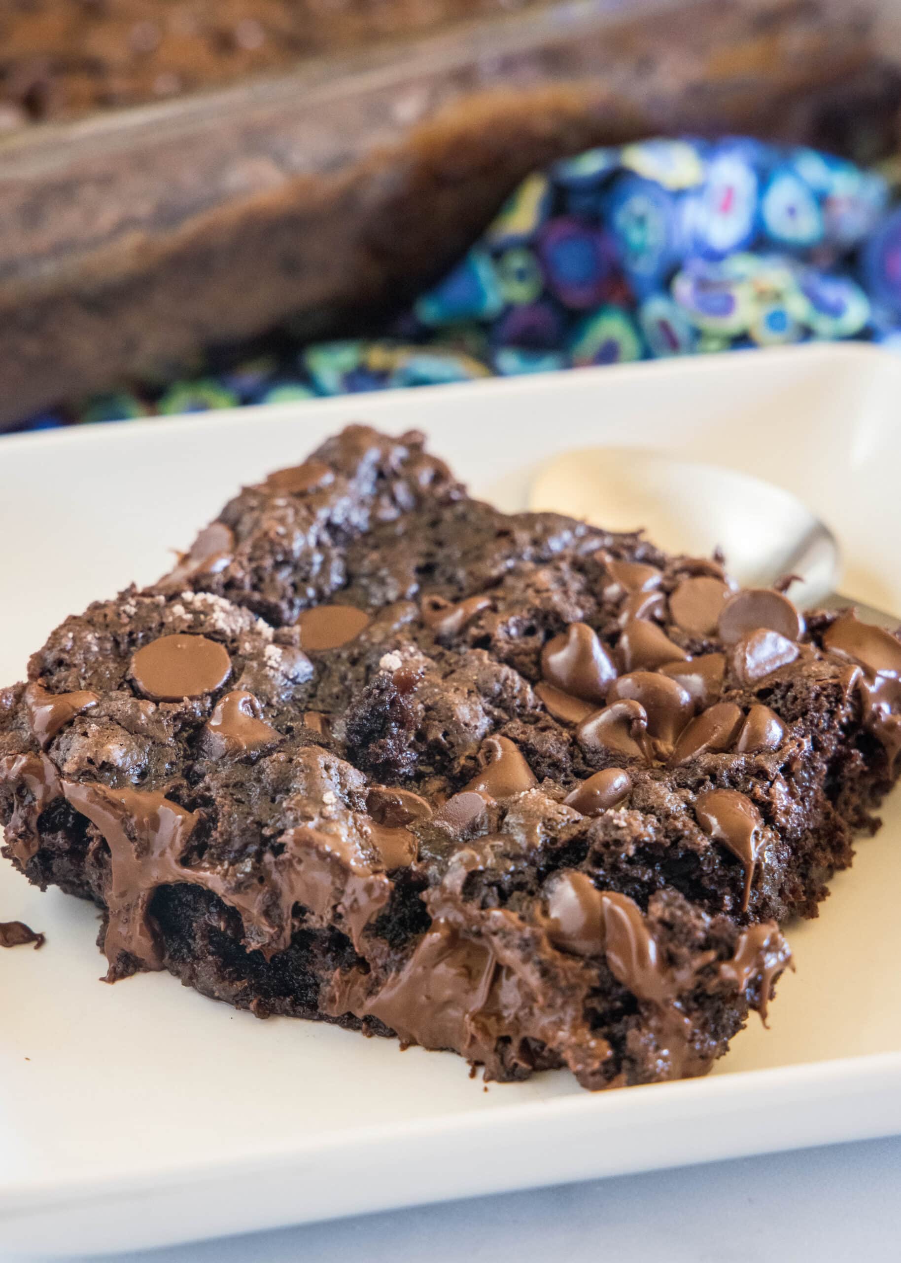 A slice of chocolate dump cake on a white plate.